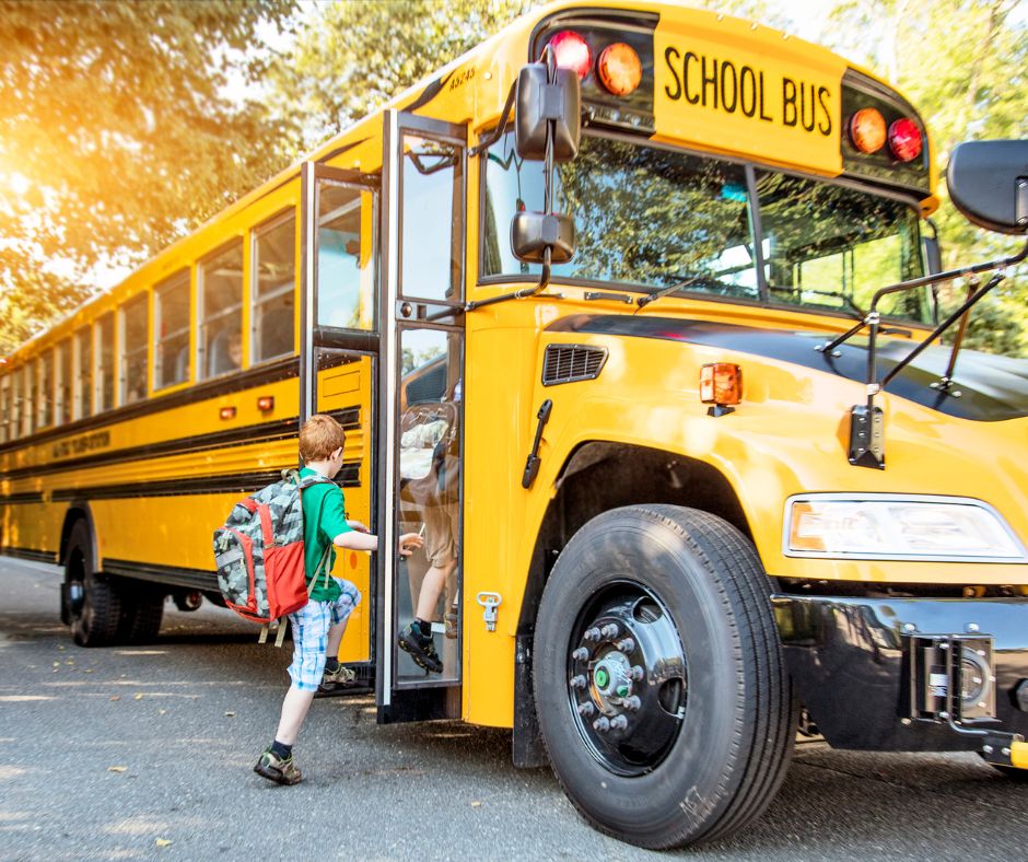 child getting onto bus