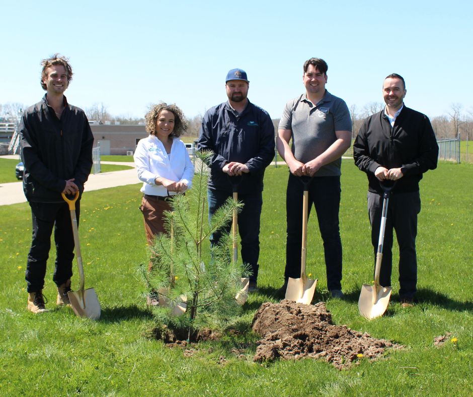 councillor lockie and heeman with staff in front of sapling pine