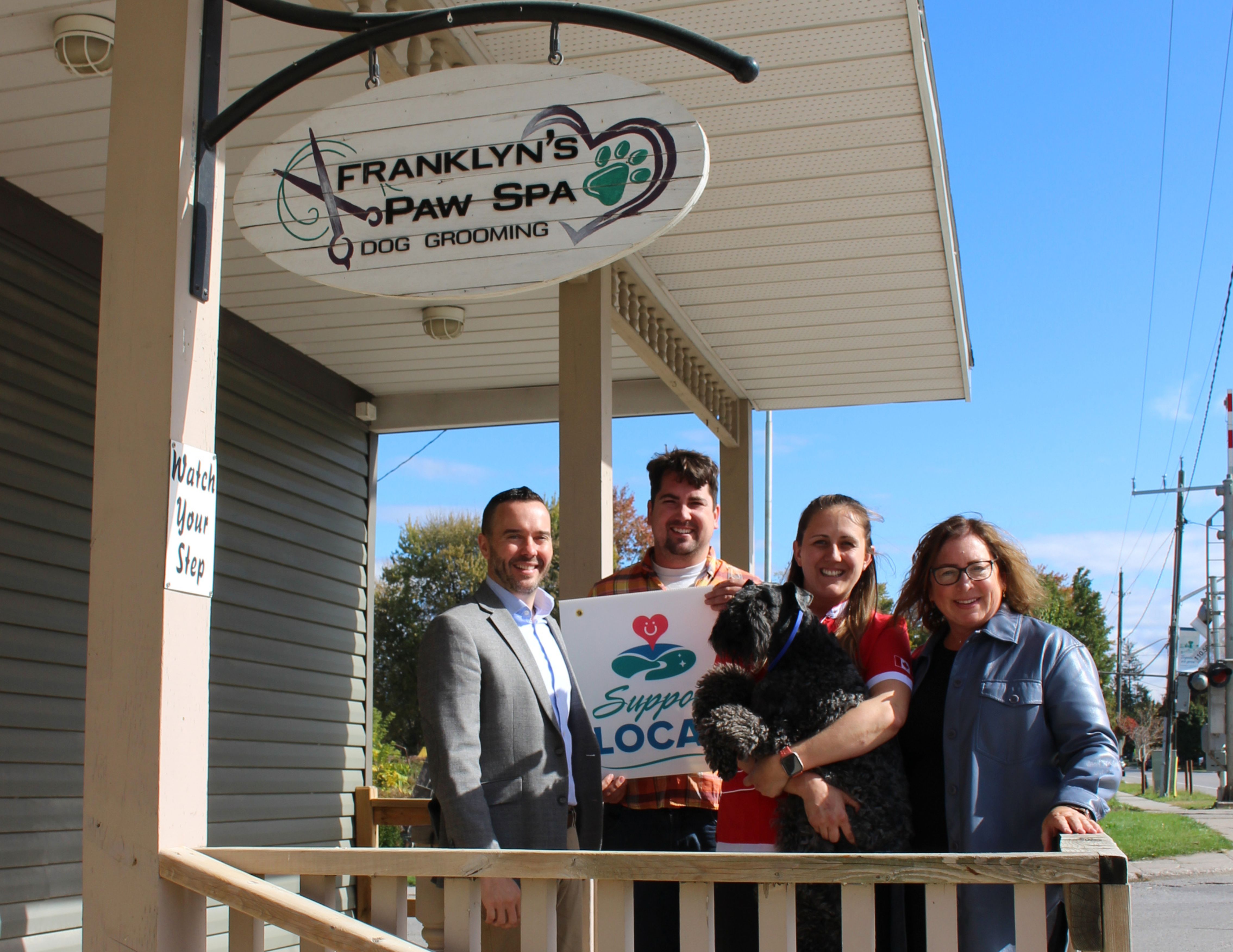 In this photo: CAO David Barrick, Ward 1 Councillor Tom Heeman, Franklyn's Paw Spa Owner Jessica Daltry, “Braz” the Jessicas Kerry Blue Terrier, and Deputy Mayor Michelle Smibert